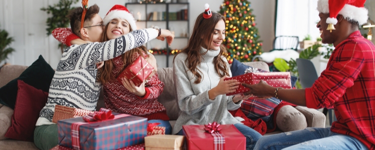 Happy friends exchanging union made holiday gifts