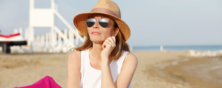 Woman on beach wearing sun glasses